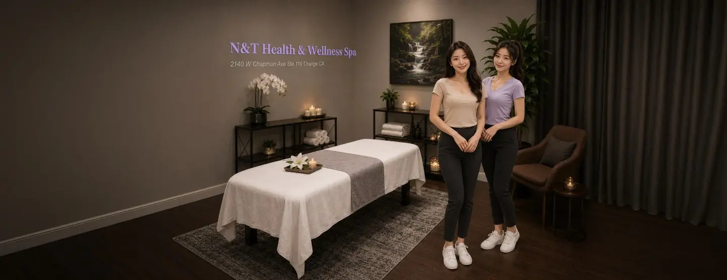 Two friendly massage therapists in a clean private treatment room at N&T Health & Wellness Spa in Orange, CA